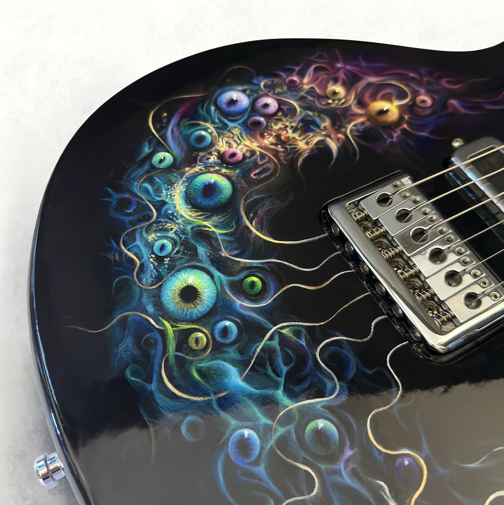 Close view of the blue, violet and silver hand-painted details of Watchful Strings.