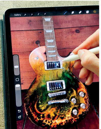 Hands refining a digital artwork concept on a tablet beside a guitar body.